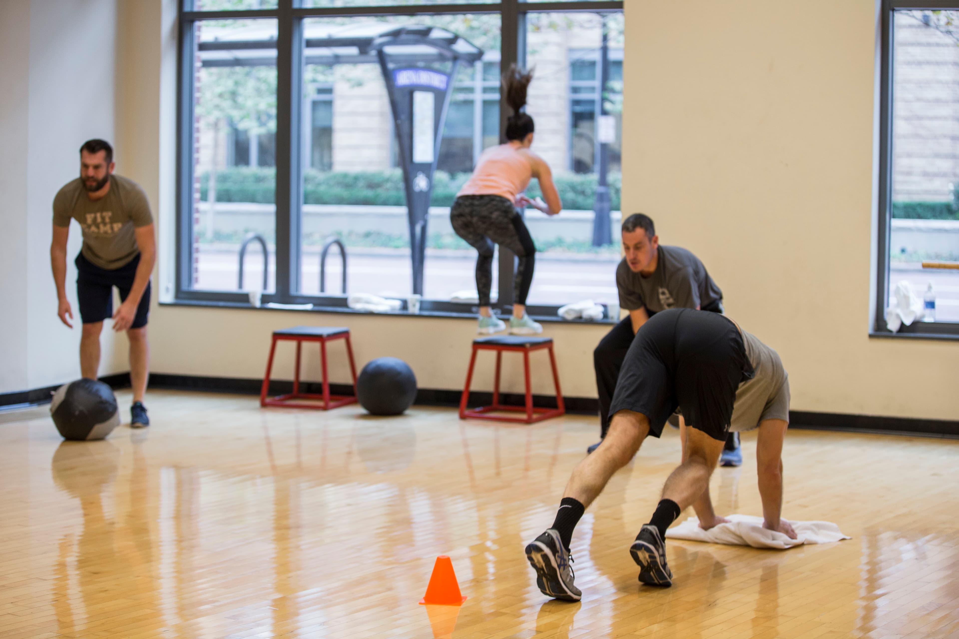 fitCAMP campers doing box jumps and towel sprints on the studio floor