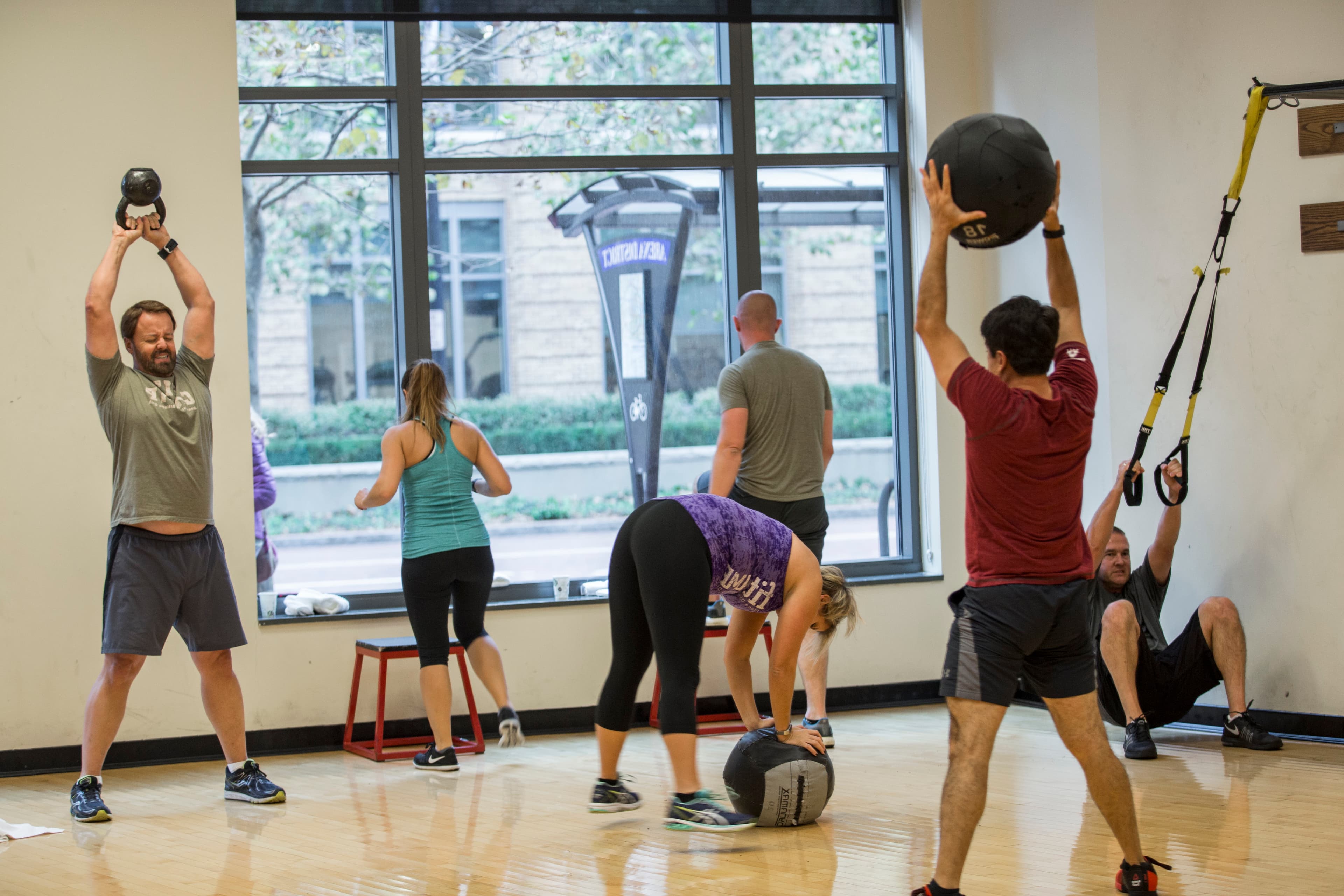 fitCAMP campers moving through a kettlebell and medicine ball circuit