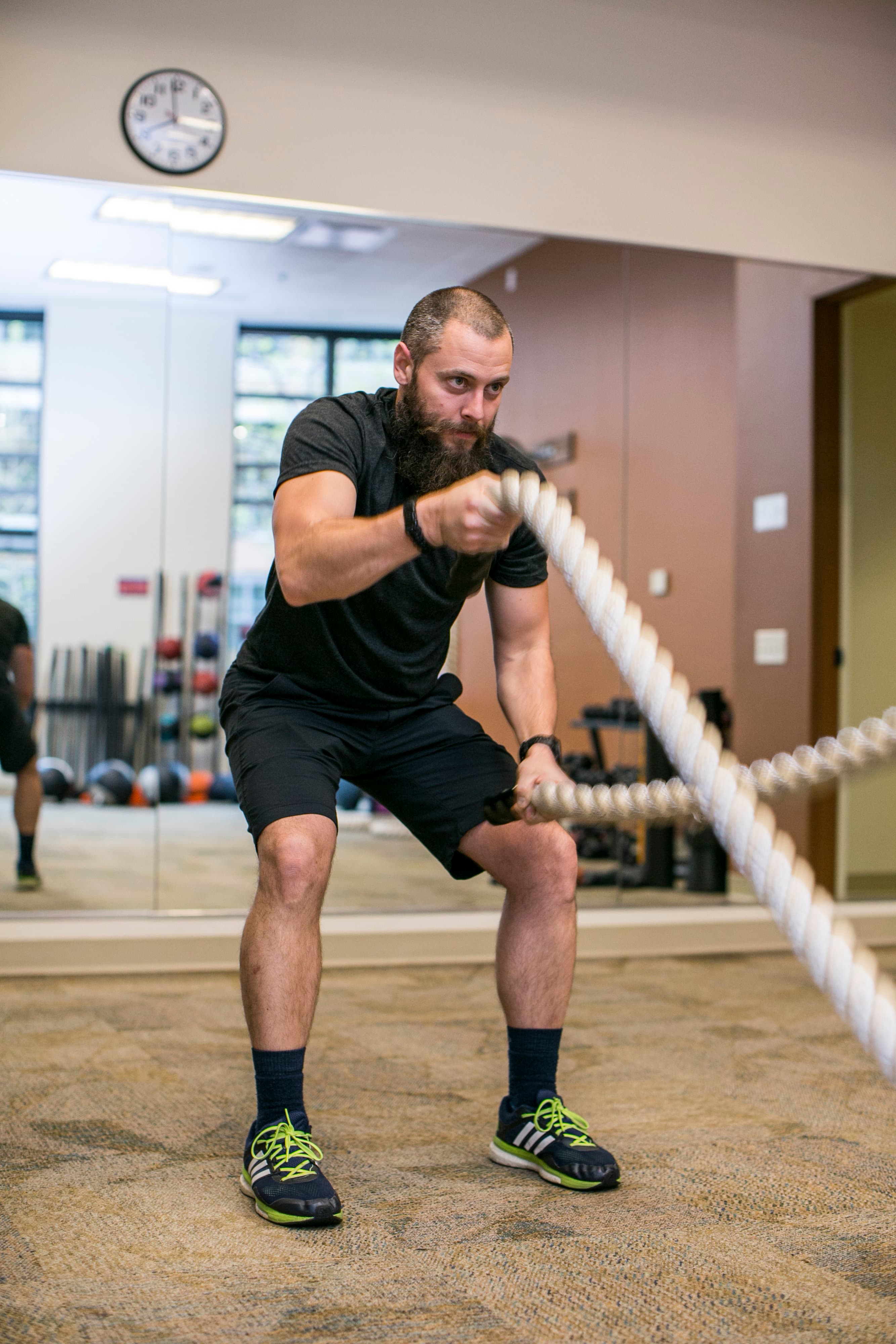 Member training with heavy battle ropes in the functional training area