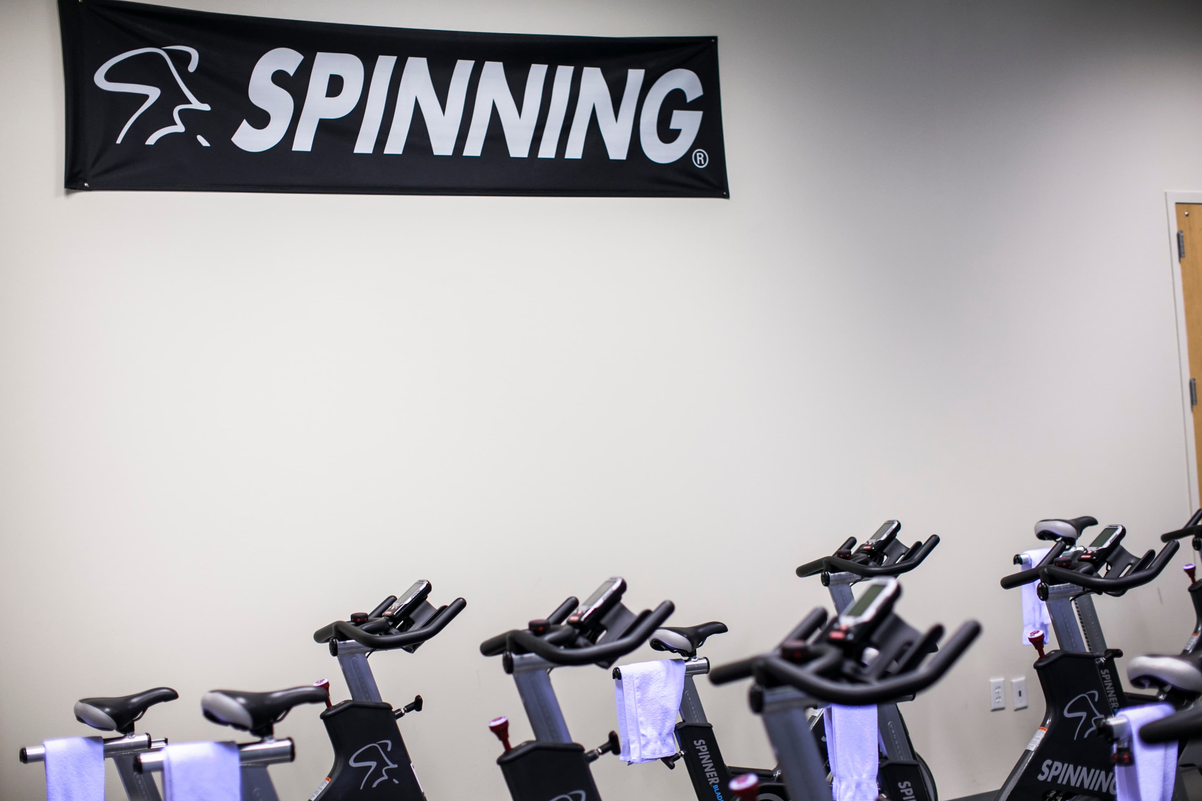 Row of Spinning bikes with towels ready in the cycling studio